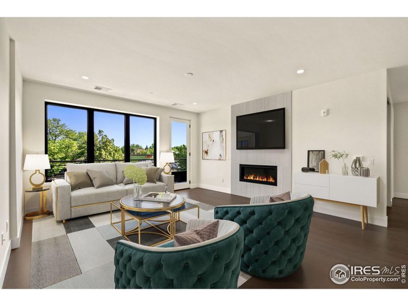 Cozy family room, with gas fireplace and 3rd story patio (virtually staged).