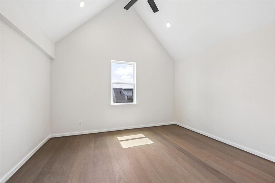 Spacious secondary bedroom featuring soaring vaulted ceilings, abundant natural light, and a bright, airy atmosphere. Spacious secondary bedroom featuring soaring vaulted ceilings, abundant natural light, and a bright, airy atmosphere.