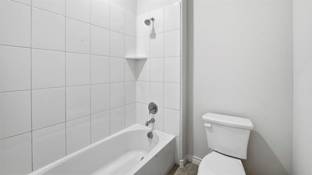 Bathroom with bathtub / shower combination and toilet Bathroom with bathtub / shower combination and toilet