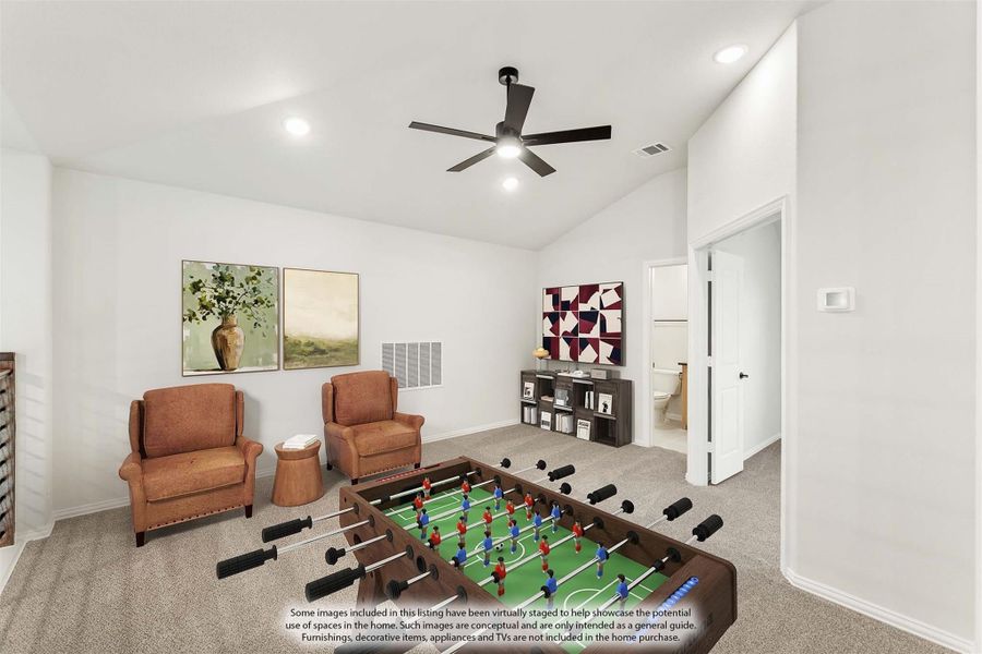 Game room with foosball table, two armchairs, carpet flooring, and ceiling fan with vaulted ceiling Game room with foosball table, two armchairs, carpet flooring, and ceiling fan with vaulted ceiling