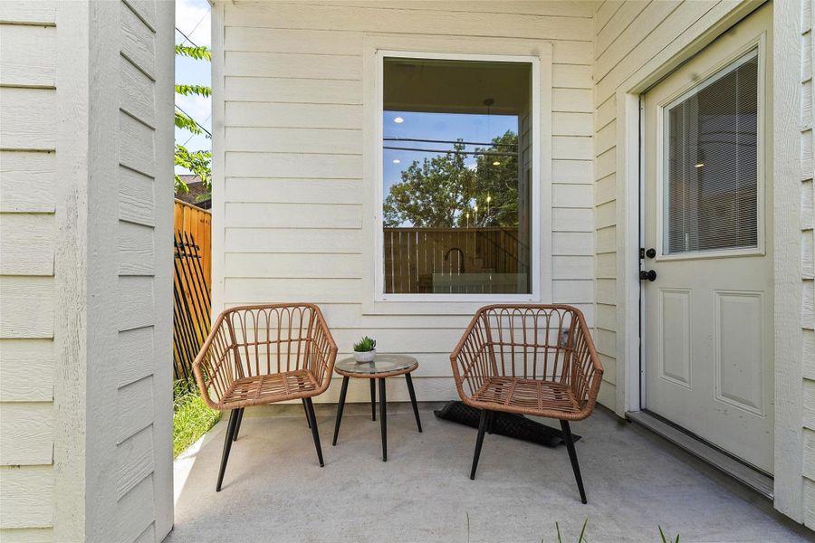 Cozy covered patio with seating, perfect for enjoying morning coffee or relaxing outdoors. Cozy covered patio with seating, perfect for enjoying morning coffee or relaxing outdoors.