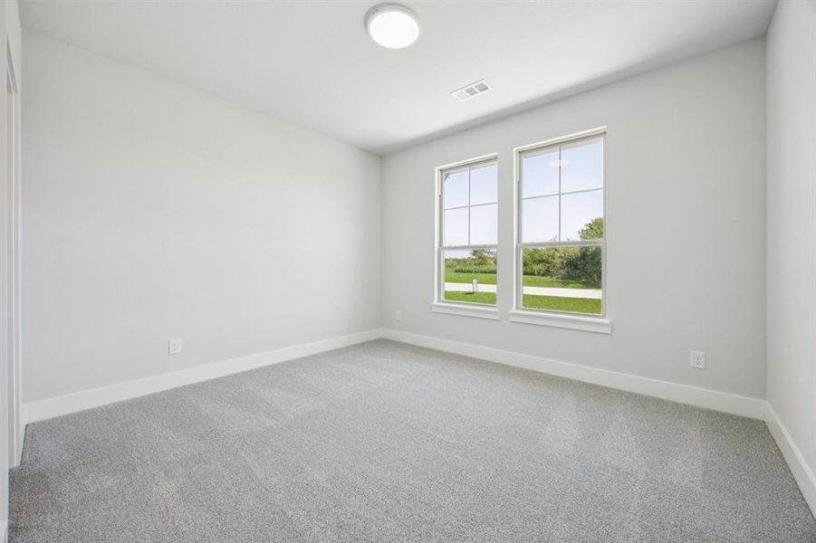 Unfurnished room featuring light carpet