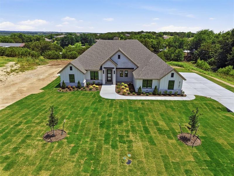 Front exterior of a new home in , Weatherford, TX, highlighting curb appeal (Image 23).