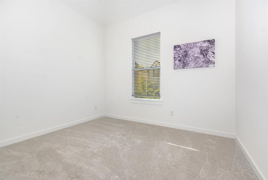 Empty room featuring light colored carpet and baseboards Empty room featuring light colored carpet and baseboards