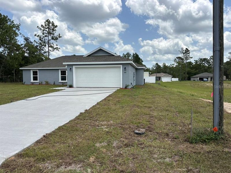 Front exterior of a new home in , Dunnellon, FL, highlighting curb appeal (Image 2). Front exterior of a new home in , Dunnellon, FL, highlighting curb appeal (Image 2).