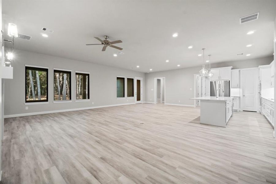 View of the family room, casual dining, and kitchen island.