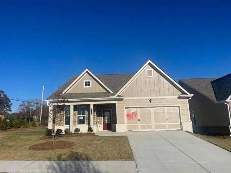 Front exterior of a new home in Cooper's Walk, Loganville, GA, highlighting curb appeal (Image 1).
