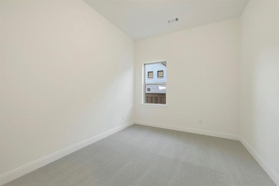 Spare room featuring light carpet and baseboards Spare room featuring light carpet and baseboards