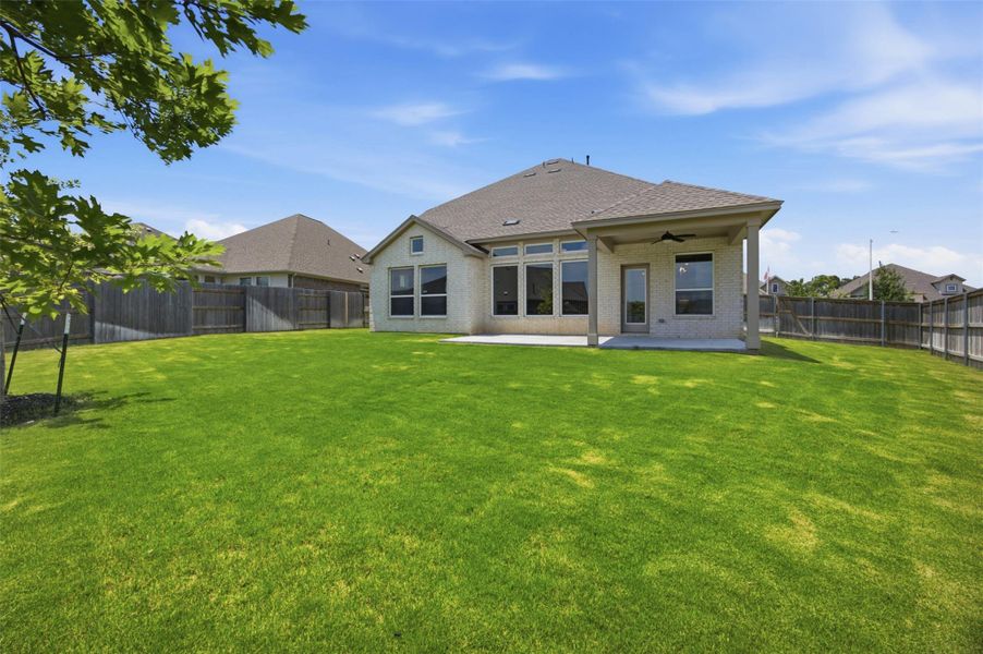 A spacious, manicured backyard offers ample room for outdoor enjoyment and relaxation.