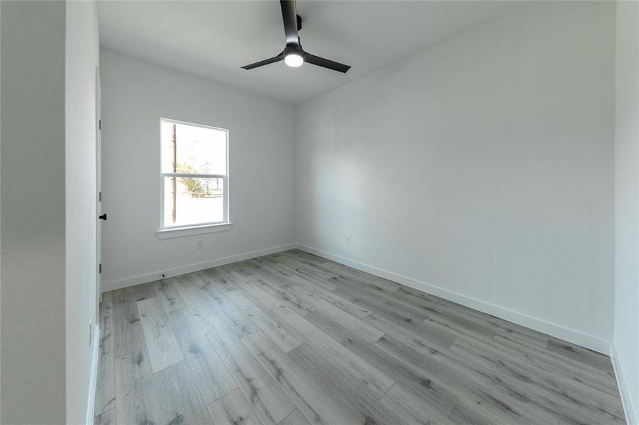 Empty room featuring ceiling fan and light hardwood / wood-style floors