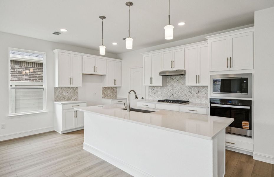 High-end gourmet kitchen with premium finishes and upgraded appliances  *Real home pictured