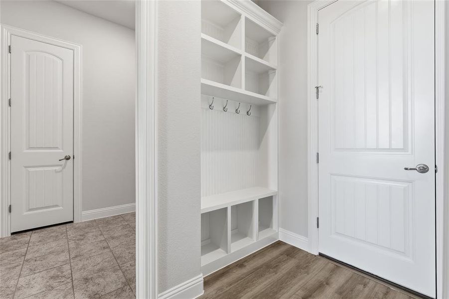 Mudroom featuring baseboards and light wood-style flooring Mudroom featuring baseboards and light wood-style flooring
