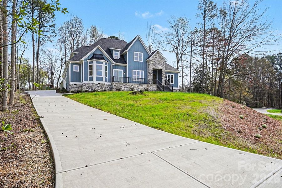 Front exterior of a new home in , Troutman, NC, highlighting curb appeal (Image 25).