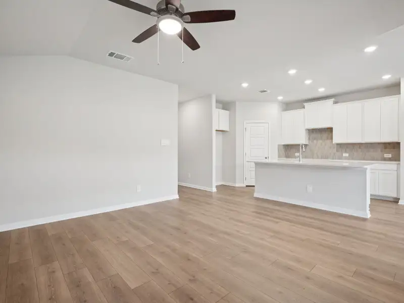 Living room and kitchen in the Briscoe floorplan at a Meritage Homes community. Living room and kitchen in the Briscoe floorplan at a Meritage Homes community.