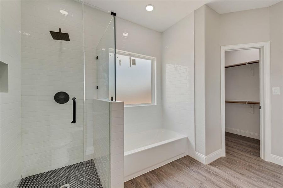 Bathroom featuring hardwood / wood-style flooring and a tile shower