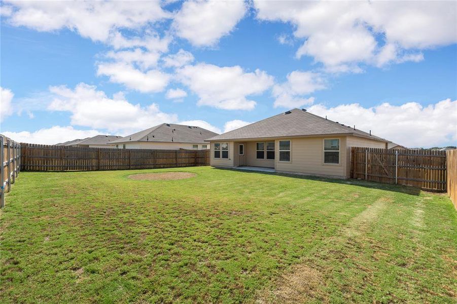 Back of house with a patio area and a fenced backyard Back of house with a patio area and a fenced backyard