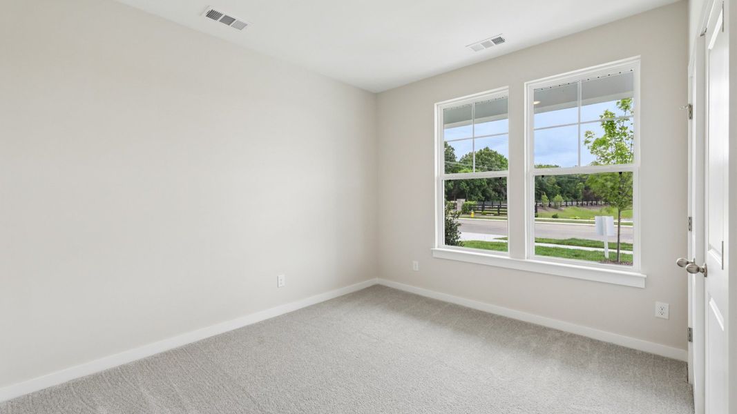 Bedroom with windows and carpet