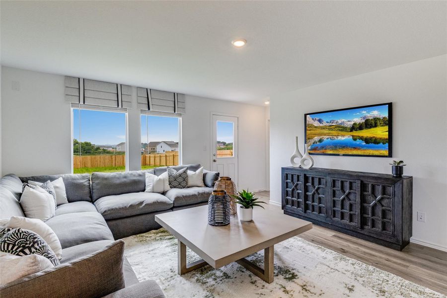 Living area with light wood-style floors and recessed lighting Living area with light wood-style floors and recessed lighting