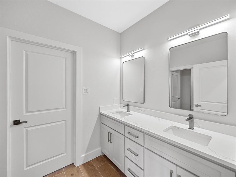 Bathroom 3 featuring double vanity and hardwood / wood-style floors