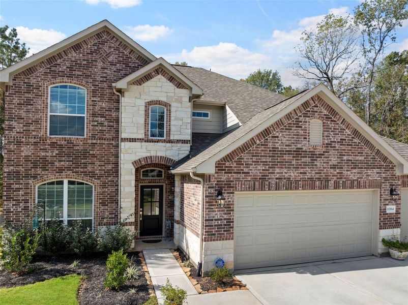 Front exterior of a new home in Oakwood Ranch, Willis, TX, highlighting curb appeal (Image 20). Front exterior of a new home in Oakwood Ranch, Willis, TX, highlighting curb appeal (Image 20).