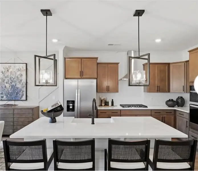 A well-appointed kitchen features a large island a A well-appointed kitchen features a large island a