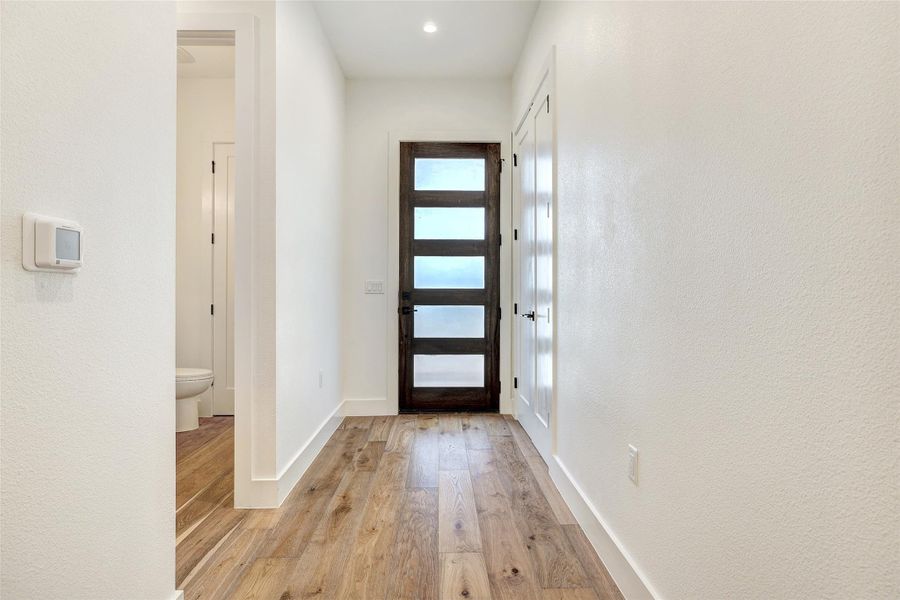 Entrance foyer featuring light wood-style floors and baseboards