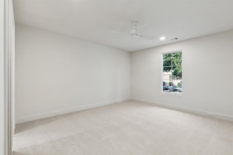 Unfurnished room with light carpet and a ceiling fan