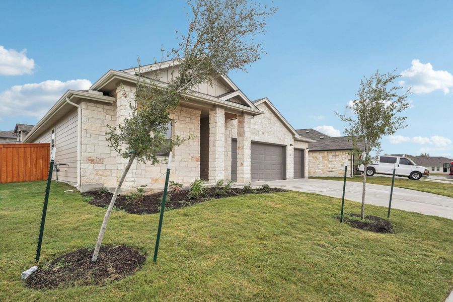 Front exterior of a new home in Crosswinds, Kyle, TX, highlighting curb appeal (Image 18).