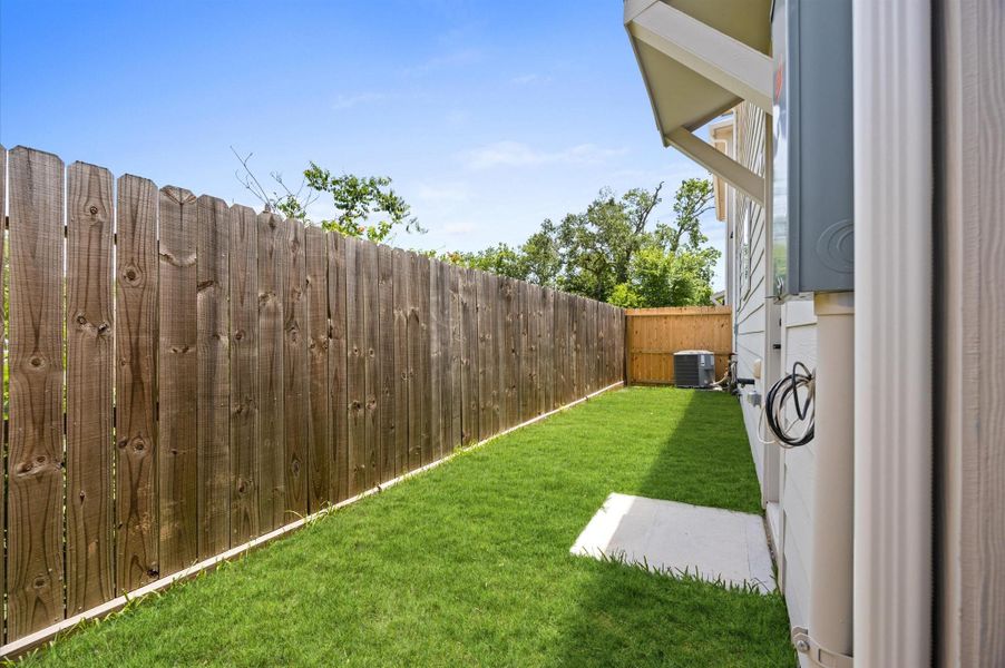 A charming backyard, enclosed by a wooden privacy fence, offers a peaceful retreat. Ideal for entertaining, gardening, or enjoying quiet moments outdoors. A charming backyard, enclosed by a wooden privacy fence, offers a peaceful retreat. Ideal for entertaining, gardening, or enjoying quiet moments outdoors.