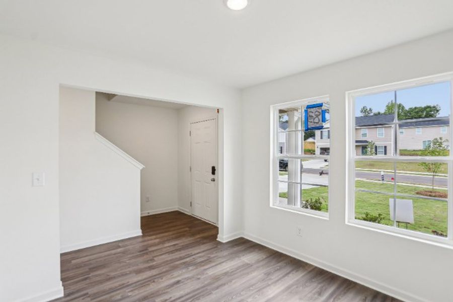 A room with a wood floor and windows.