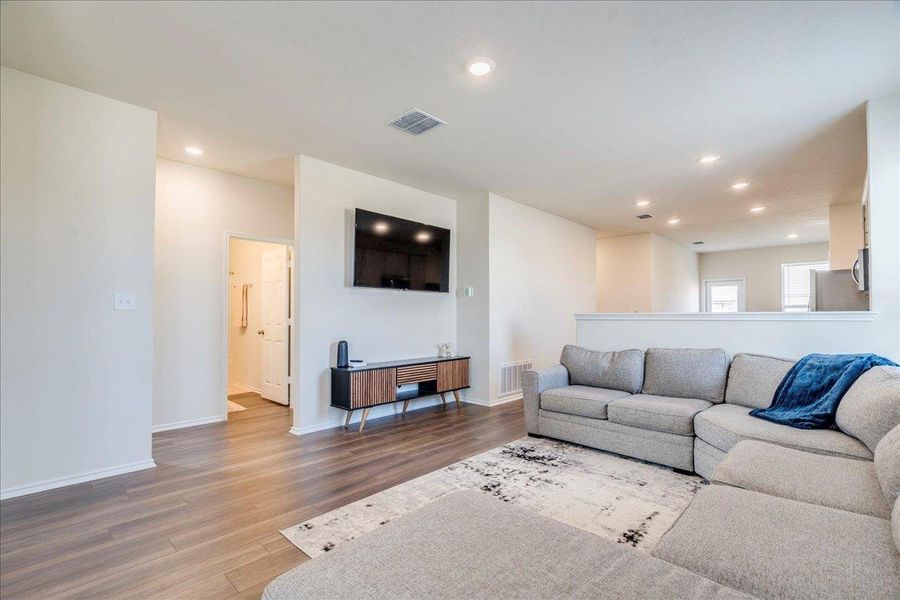Living room features recessed lighting and LVP flooring Living room features recessed lighting and LVP flooring