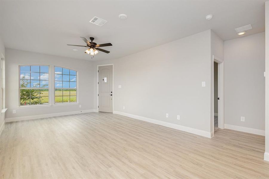 Unfurnished living room with light wood finished floors, a ceiling fan, and recessed lighting