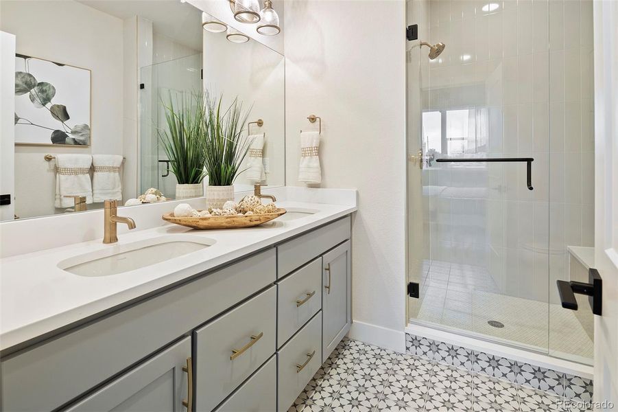 En suite primary bath with dual vanity and shower w/bench En suite primary bath with dual vanity and shower w/bench