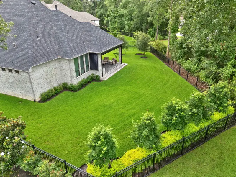 From above, the backyard showcases the premium lot, generous green space, and room for a future pool. The home’s placement offers an open, private feel with beautiful separation from surrounding properties.