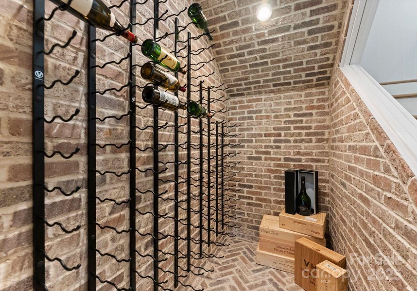Custom walk-in wine closet with glass window open to staircase and accessed from the living room. Offers built in wine cooling/humidity system for quality storage/collecting Custom walk-in wine closet with glass window open to staircase and accessed from the living room. Offers built in wine cooling/humidity system for quality storage/collecting