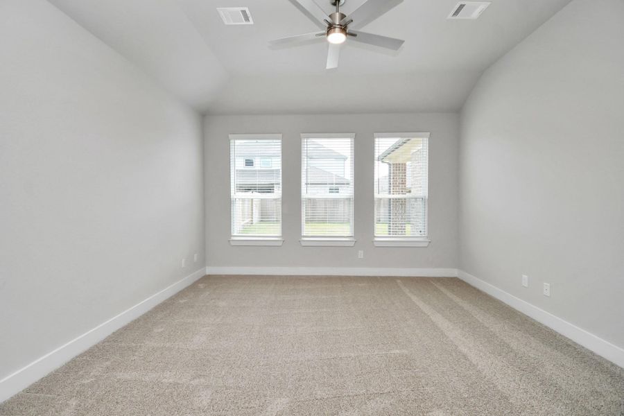 Escape to tranquility in this spacious primary room, adorned with plush carpeting and bathed in the soothing hues of warm paint colors, creating a cozy retreat for relaxation. Escape to tranquility in this spacious primary room, adorned with plush carpeting and bathed in the soothing hues of warm paint colors, creating a cozy retreat for relaxation.