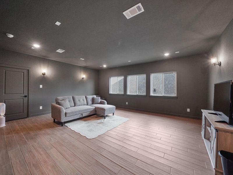 Movie nights come to life in the private media room, with darkened walls and plenty of space to add your dream theater setup.