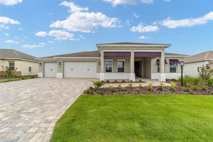 Front exterior of a new home in On Top of the World Communities, Ocala, FL, highlighting curb appeal (Image 17).