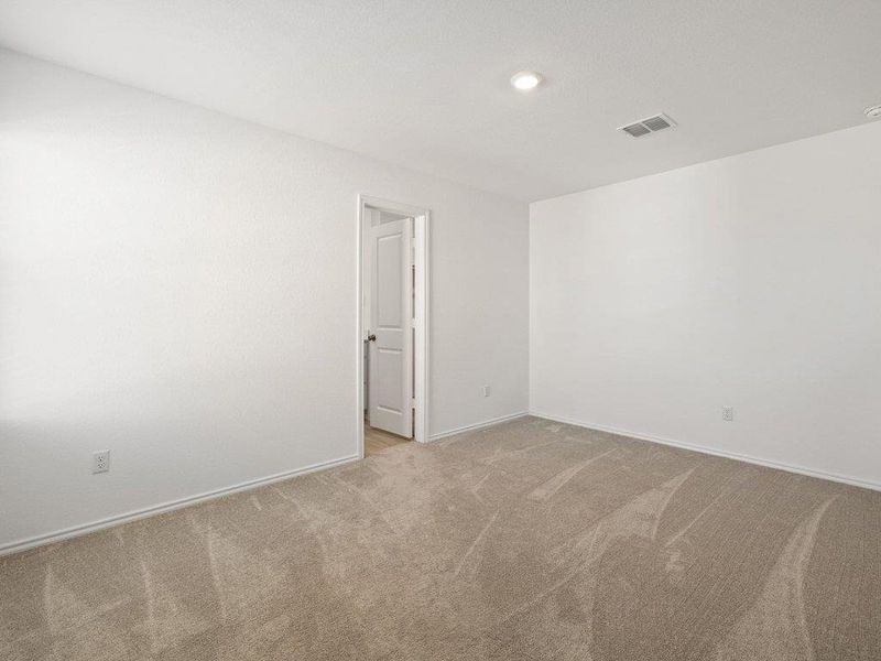 Carpeted spare room featuring baseboards