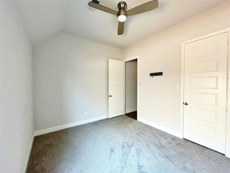 Unfurnished bedroom with carpet and ceiling fan Unfurnished bedroom with carpet and ceiling fan