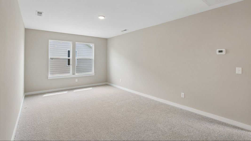 Second Floor Loft area with windows and carpet