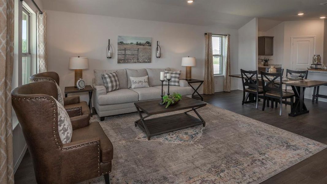 Living area featuring dark wood-style flooring and recessed lighting