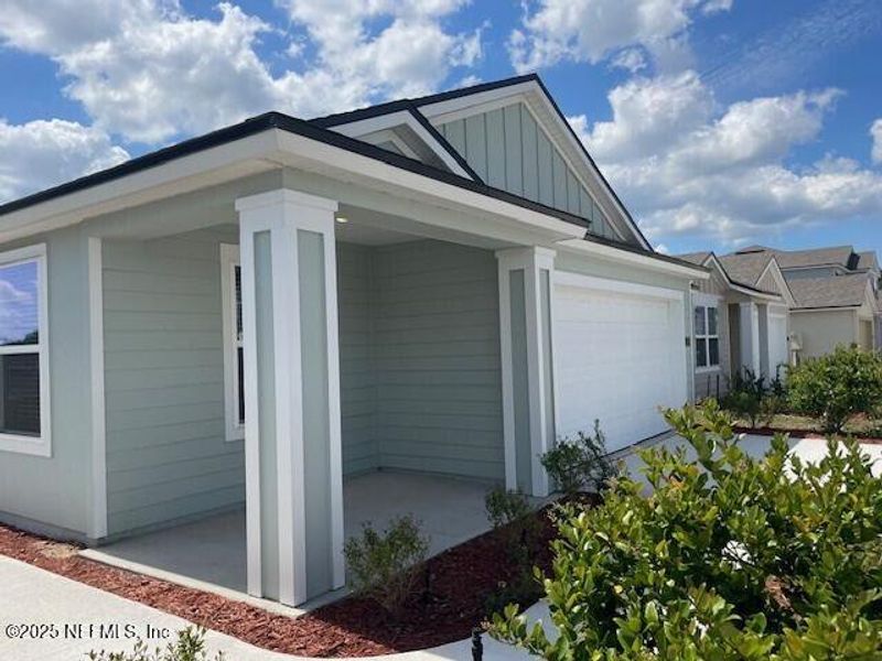 Front exterior of a new home in The Arbors, Jacksonville, FL, highlighting curb appeal (Image 24).