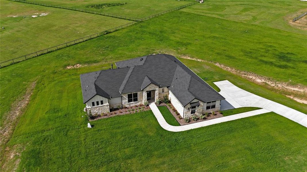Front exterior of a new home in , Poolville, TX, highlighting curb appeal (Image 1). Front exterior of a new home in , Poolville, TX, highlighting curb appeal (Image 1).