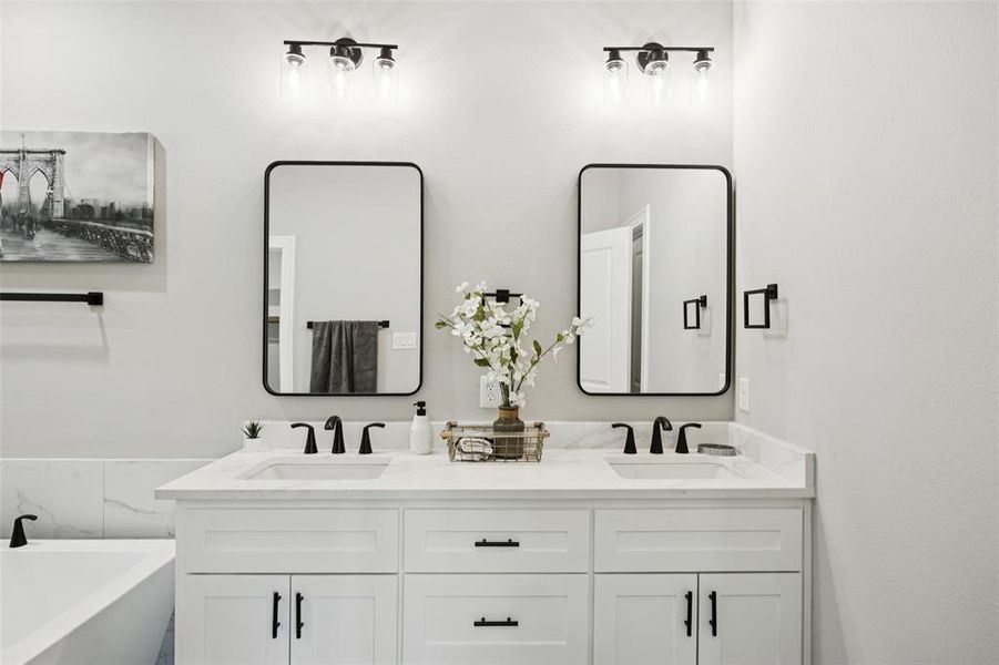 Bathroom featuring a freestanding tub and double vanity