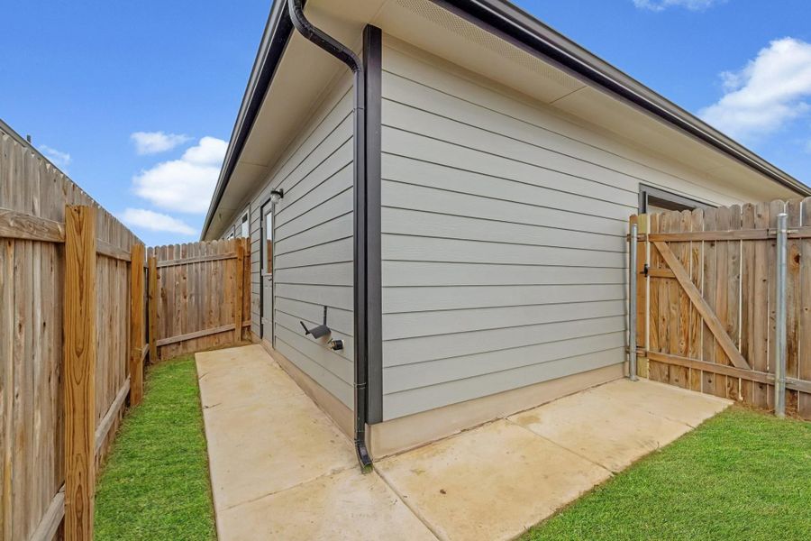 View of outdoor structure featuring a gate and a fenced backyard