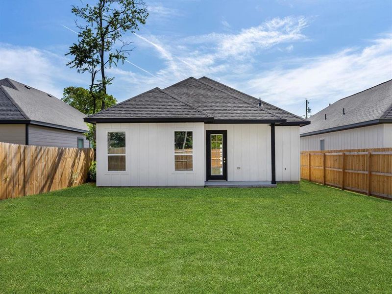 Rear view of property featuring a yard