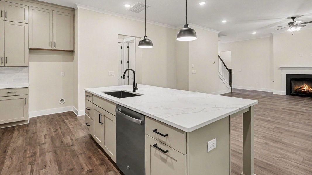 Kitchen with quartz countertops, tile backsplash, and light cabinetry Kitchen with quartz countertops, tile backsplash, and light cabinetry