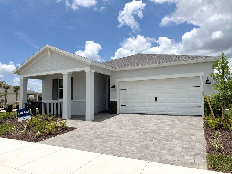 Front exterior of a new home in Crescent Lakes - Reserve Series, Punta Gorda, FL, highlighting curb appeal (Image 2). Front exterior of a new home in Crescent Lakes - Reserve Series, Punta Gorda, FL, highlighting curb appeal (Image 2).