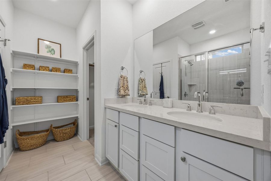 Double vanity with undermount sinks and light-toned countertops